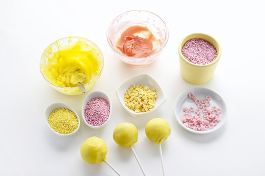 Yellow and pink icing and colorful sprinkles
