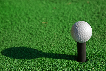 Golf ball on tee and imitate green