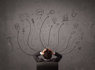 Businessman in front of a chalkboard deciding with arrows and si