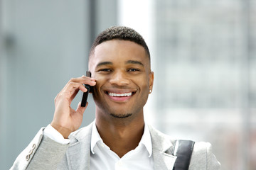 Handsome young man smiling with mobile phone