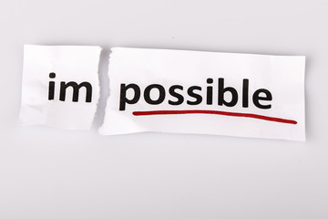 The word impossible changed to possible on torn paper
