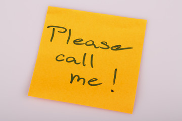 Please call me note on orange sticker note on white