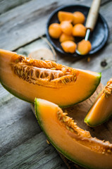 Sliced melon on wooden background
