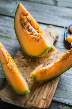 Sliced melon on wooden background