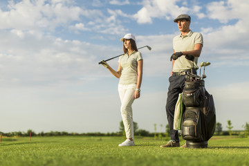 Young couple at golf cart