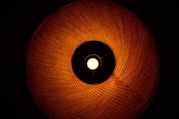 The lampshade with lamp in yellow-orange tones