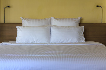 Fototapeta na wymiar Double comfortable bed in hotel