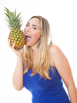 Young healthy beautiful woman with a pineapple