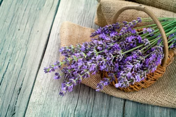 Foto auf Acrylglas lavender flowers in a basket with burlap on the wooden backgroun © motorolka