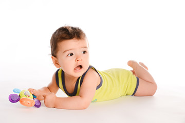 isolated studio portrait of lovely toddler baby boy playing