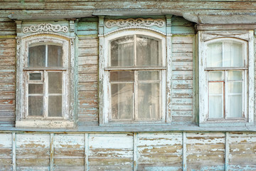 Old windows of obsolete wooden traditional Russian house.