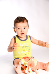 isolated studio portrait of lovely toddler baby boy playing