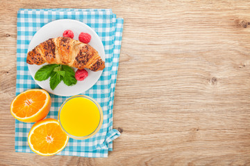 Orange juice and fresh croissant