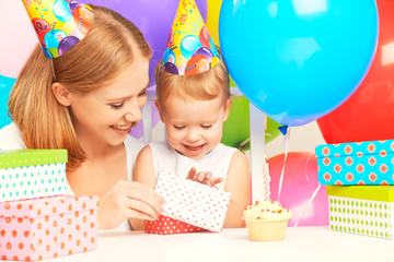 happy birthday. mother giving  gift to  daughter with balloons