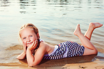 Young girl posing for the camera on shore