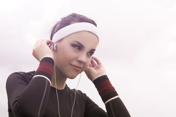 Portrait of Fitness Caucasian Woman Listening to Music during He