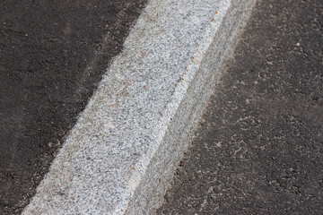 white curb and asphalt road