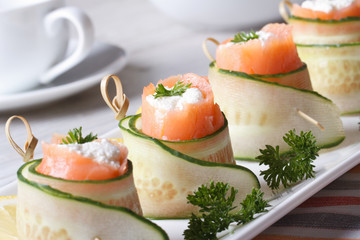 salmon rolls with cucumber, cream cheese and herbs