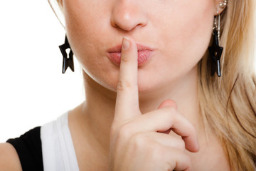 Naklejka premium Closeup of girl with finger on lips asking for silence