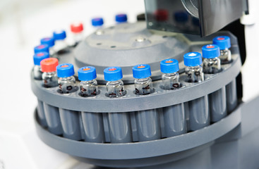 Close-up little laboratory flasks in cartridge