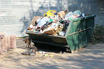 Overfilled trash dumpster in ghetto neigborhood in Russia