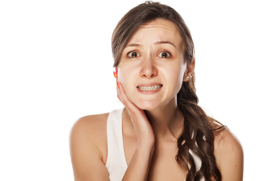 frightened young woman posing on a white background