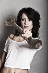 Sexy girl holding wrench spanner tool