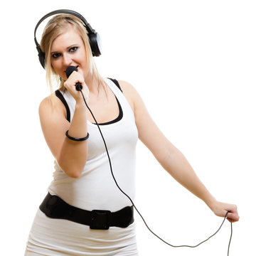 girl singer musician with headphones singing to microphone