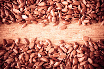 Healthy diet. Flax seeds linseed border on wooden background