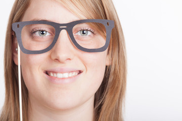 Portrait of young woman wearing funny eyeglass mask