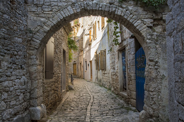 Fototapeta na wymiar Old and narrow street, paved of cobble stones, Bale, Croatia