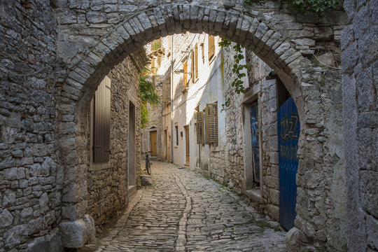 Old and narrow street, paved of cobble stones, Bale, Croatia