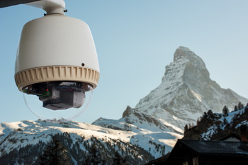 Obraz premium CCTV Camera or surveillance orperating with Matterhorn snow moun