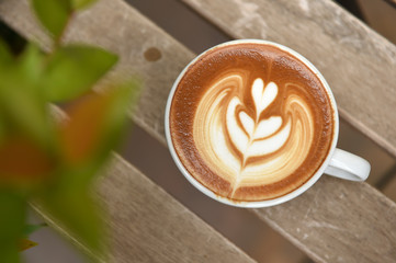 a cup of latte art coffee on table