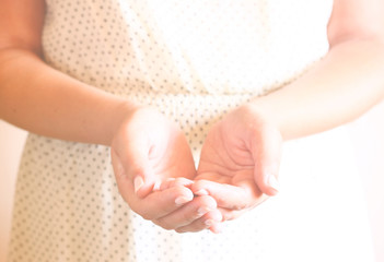 closeup of young woman hands. hands outstretched in cupped shape