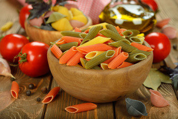 Uncooked pasta in wooden bowl