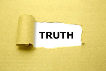 Truth text appearing behind torn brown paper.