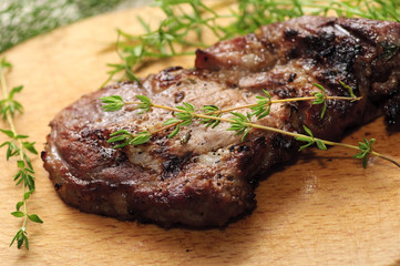 Roasted spiced pork steak with thyme branches