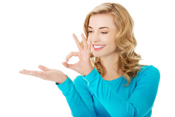 Fototapeta premium Woman showing something or copyspase