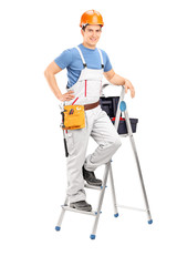 Male electrician standing on a ladder