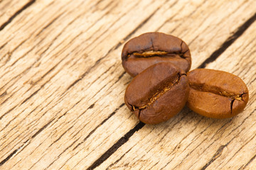 Roasted coffee beans on old wooden table - view from top