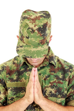 War Soldier Praying In Military Camouflage Uniform With Head Bow