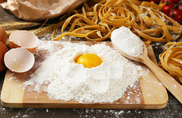 Still life with raw homemade pasta and ingredients for pasta