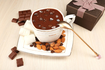 Cup of hot chocolate on table, close up