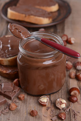 Sweet chocolate cream in jar on table close-up