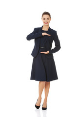 Business woman showing something or copyspase