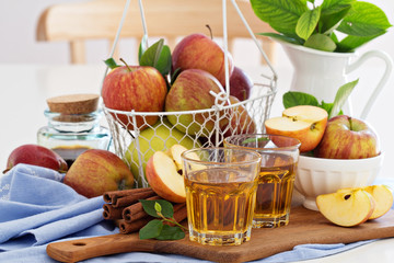 Apple juice and fresh apples on the table