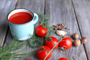 Homemade tomato juice in color mug, spices and fresh tomatoes