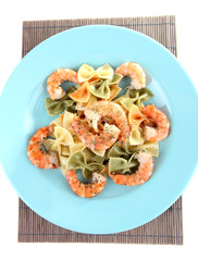 Fresh prawns with coloured macaroni in a big blue plate
