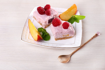 Cake with fruits and berries on plate on wooden background